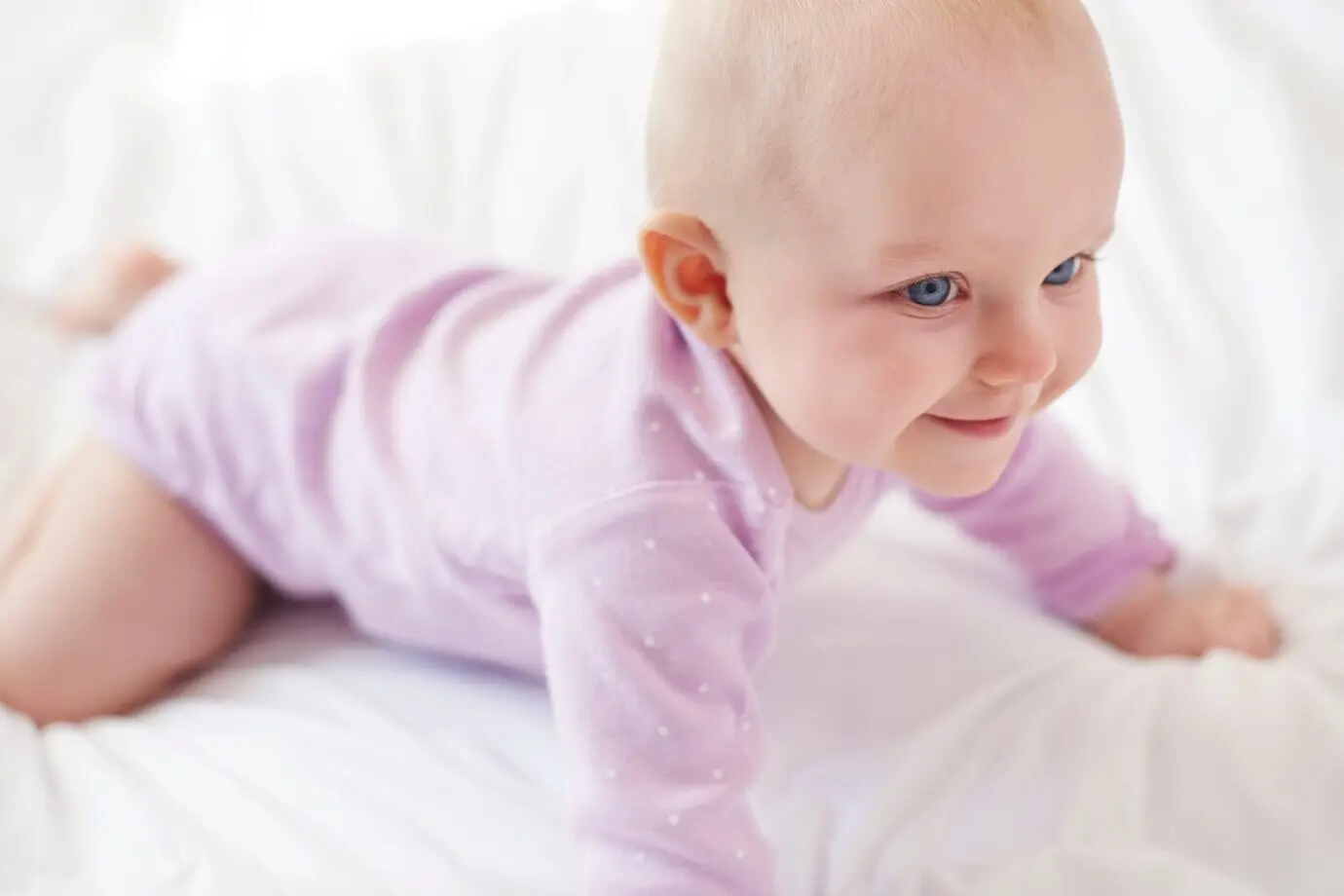 A strong, cute little girl starts crawling.